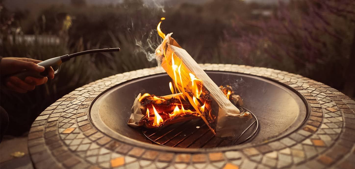 duraflame OUTDOOR firelogs are stacked and burning for a fire pit party