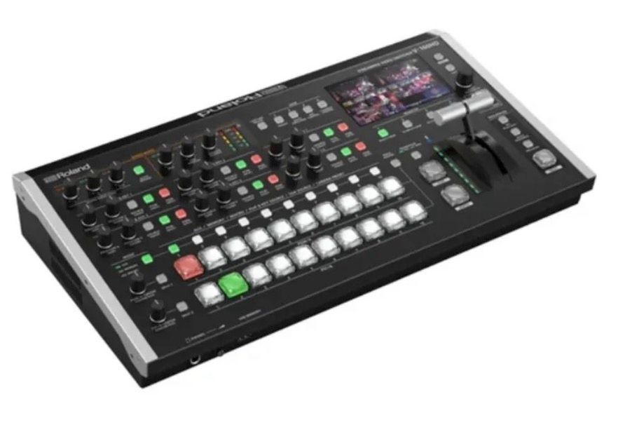 A black Roland V-60HD video production switcher with multiple buttons, control knobs, and a T-bar fader.