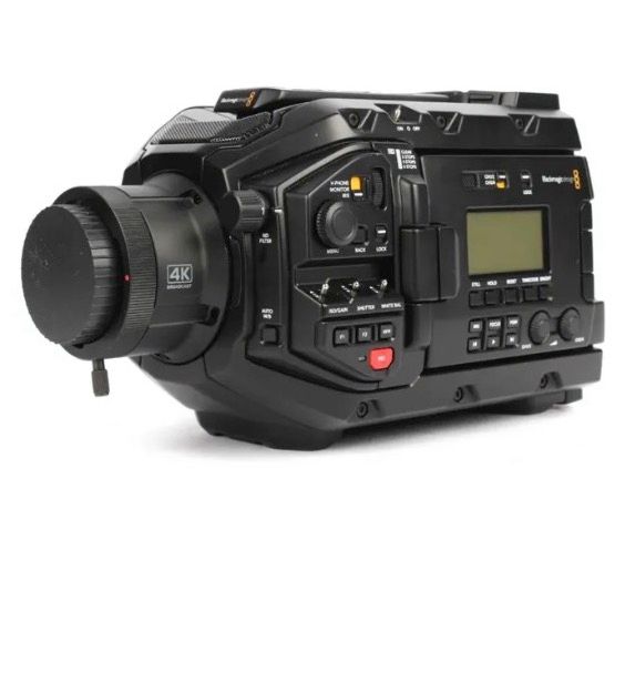 A black Blackmagic Design URSA Mini 4K digital cinema camera body shown from a side angle with a lens cap attached.