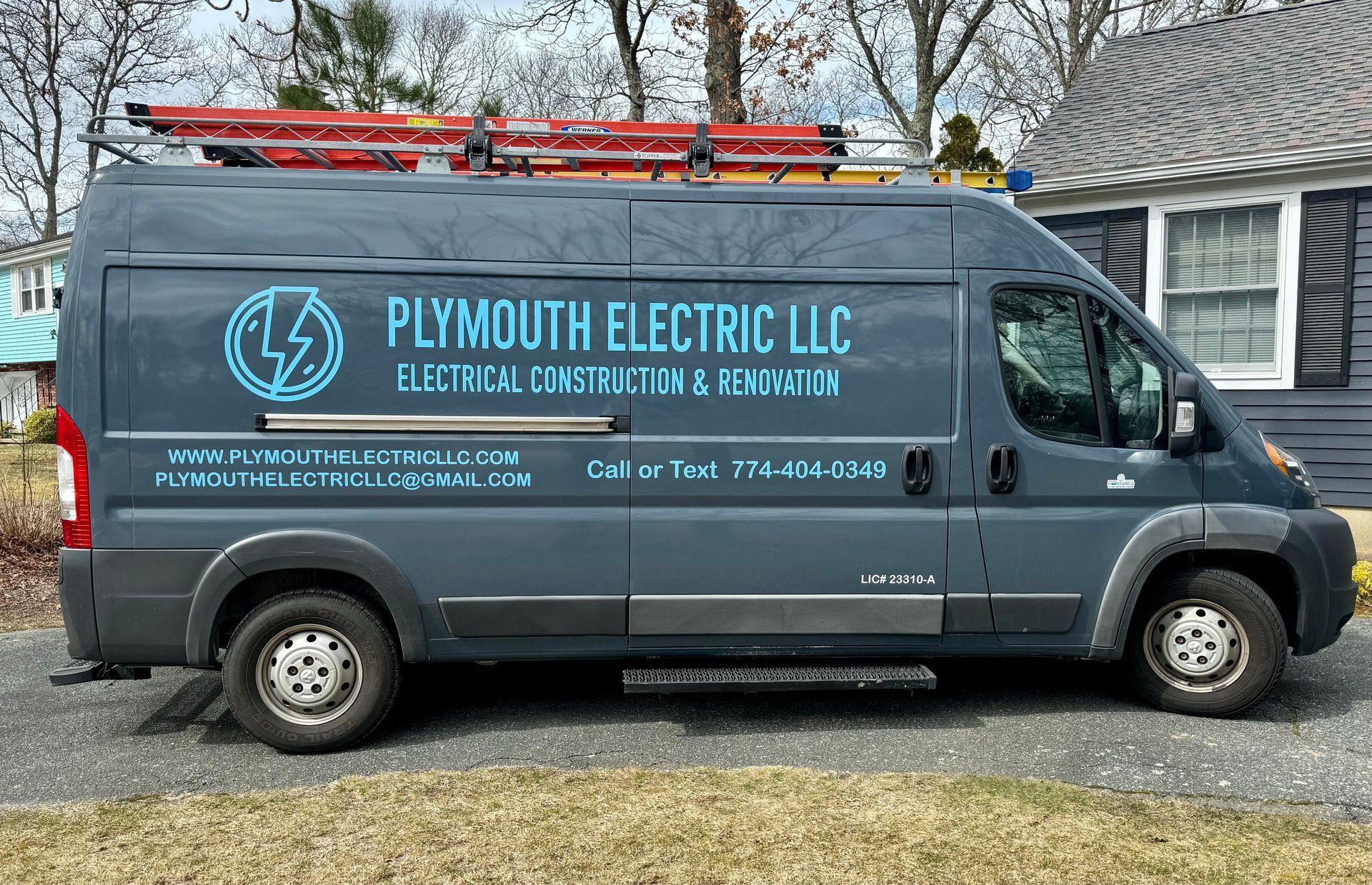 A plymouth electric llc van is parked in front of a house.