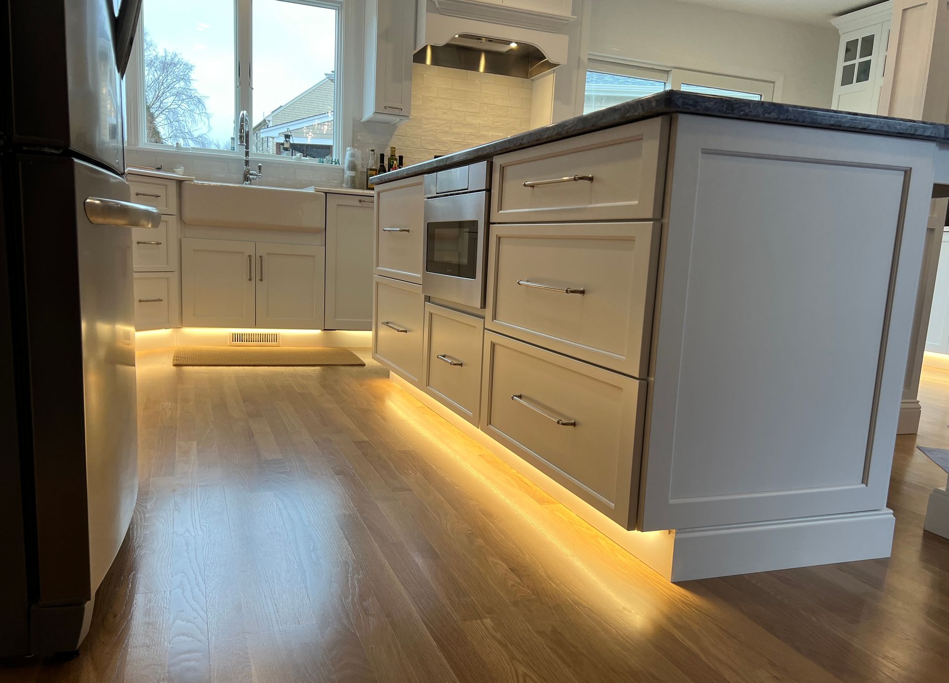 A kitchen with a large island and lots of cabinets and drawers.