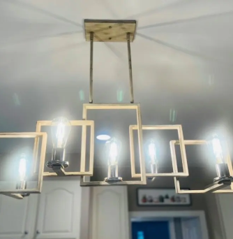 A chandelier is hanging from the ceiling in a kitchen