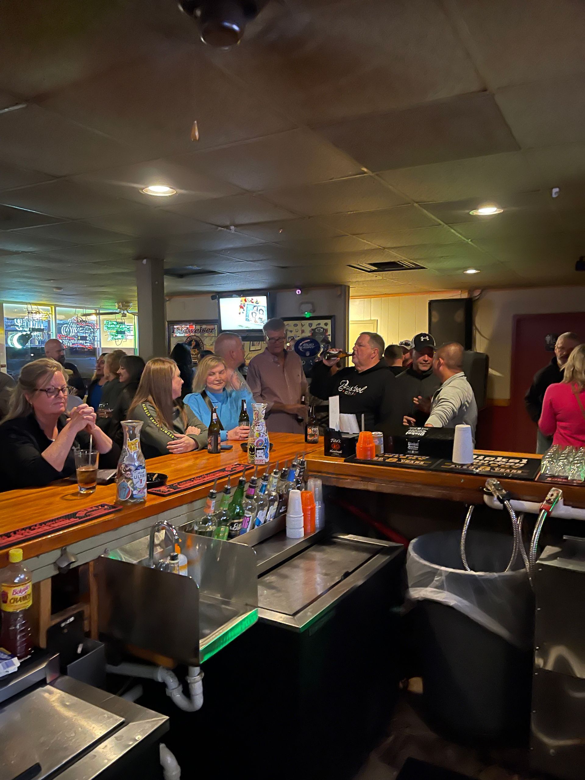 A group of people are sitting at a bar.