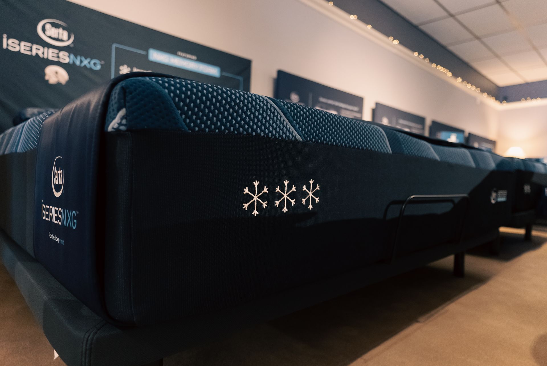 Black Iseries XNG exhibition display with glowing icons in a showroom-like setting