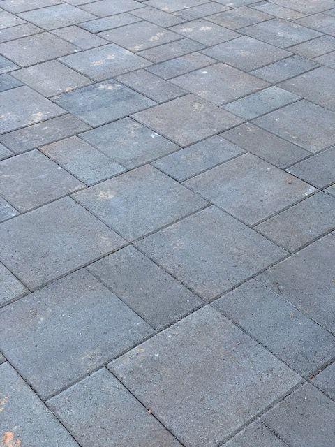 Gray stone pavement with rectangular pavers arranged in a staggered pattern