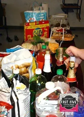 A table full of food and drinks including ritz chips