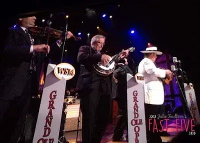 A group of men are playing musical instruments on a stage.