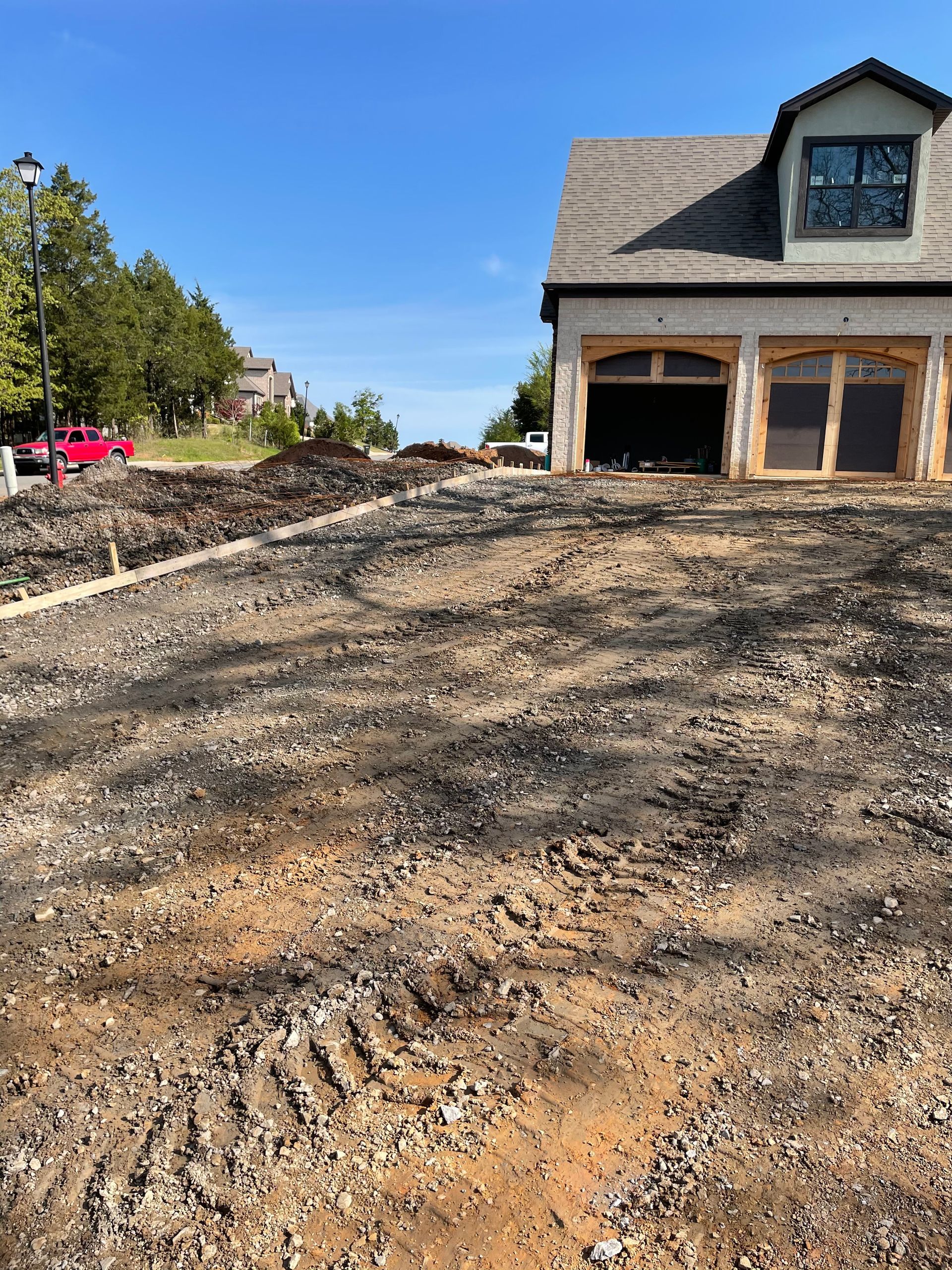 A house is being built in the middle of a dirt field.