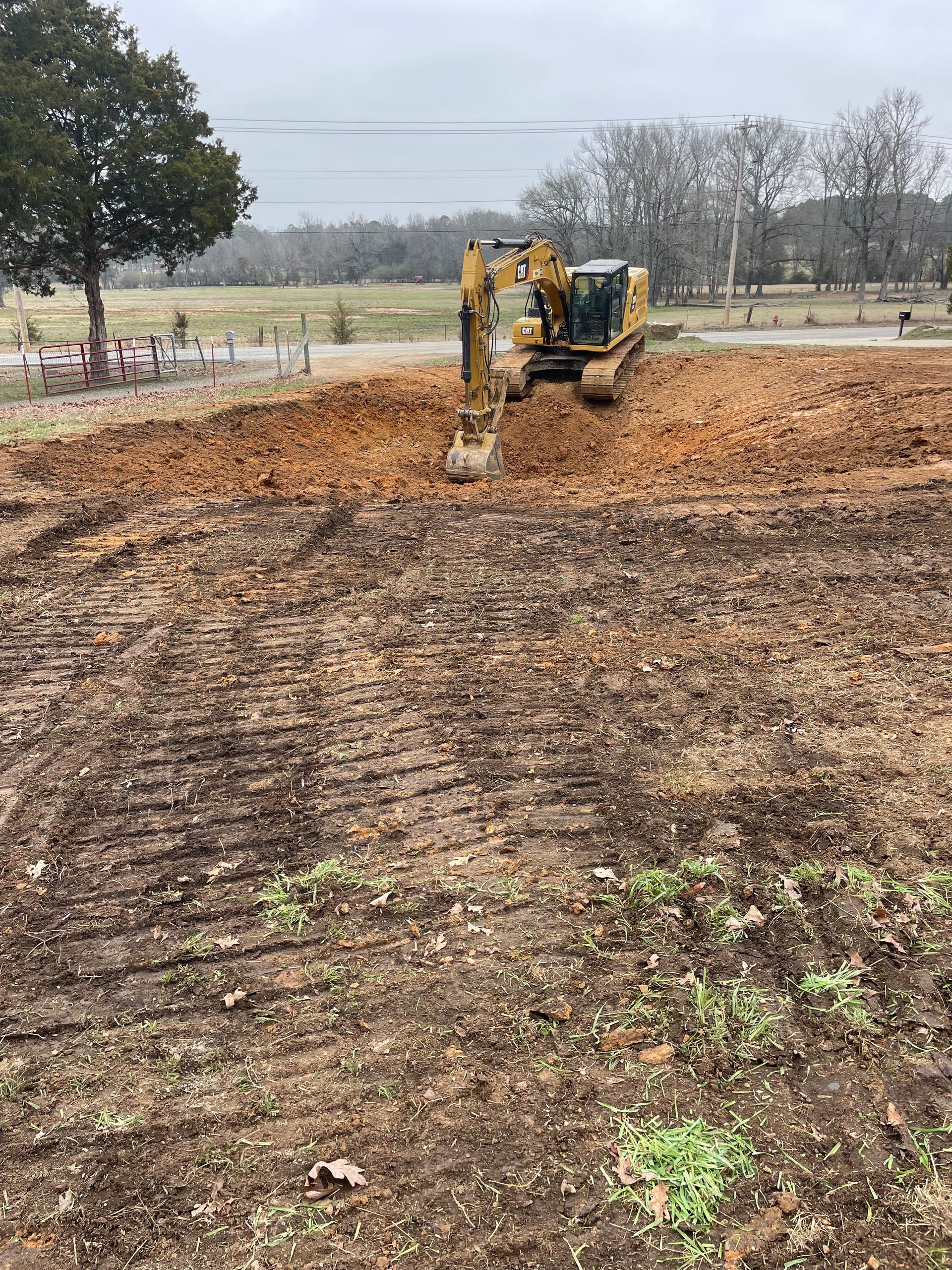 A bulldozer is moving dirt in a field.