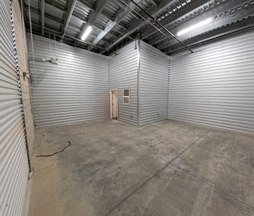 Empty warehouse room with door to office