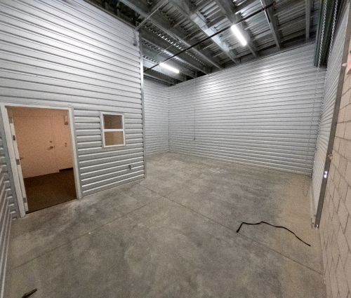 Empty warehouse room with door to office
