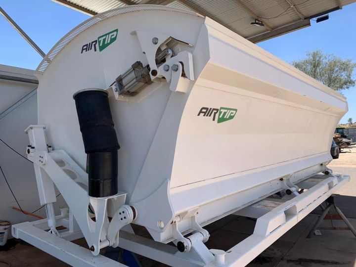 White Air Tip agricultural machine on a trailer, for applying chemicals or fertilizer to crops. It's in an outdoor setting.
