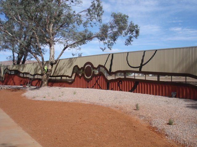 Fence with Aboriginal art design.