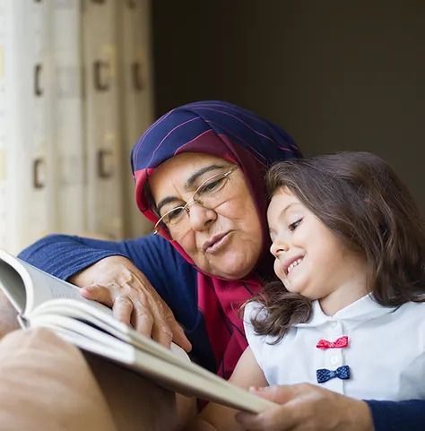 woman reading stories to a girl