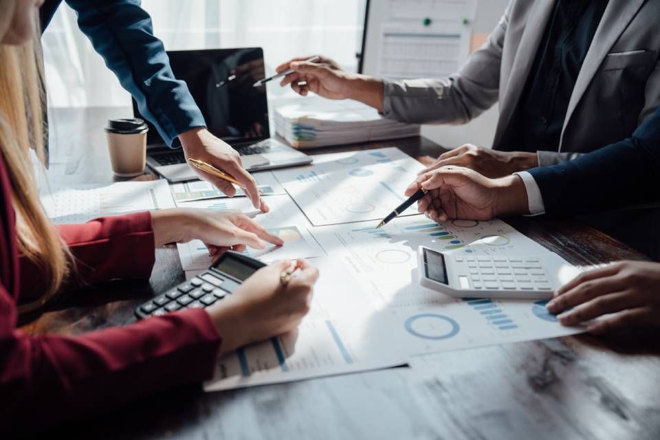 Team reviewing financial charts and documents at a conference table