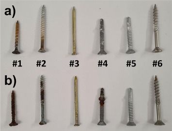 A bunch of different types of screws are lined up on a table