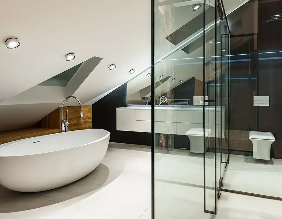 Modern bathroom with freestanding tub, glass shower, and sleek white-and-black minimalist design