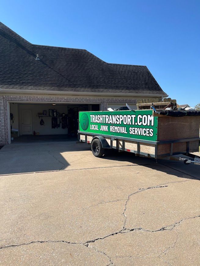 Green banner on trailer in front of a house that reads 