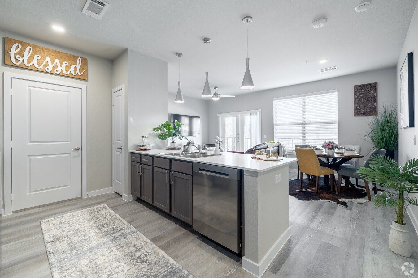 Urban Village at Rosehill apartment open floor plan layout with the kitchen overlooking the living room.
