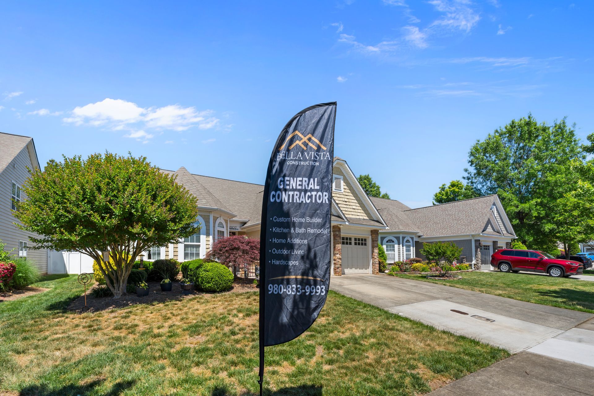 Residential house for sale sign in front of a suburban home on a sunny day