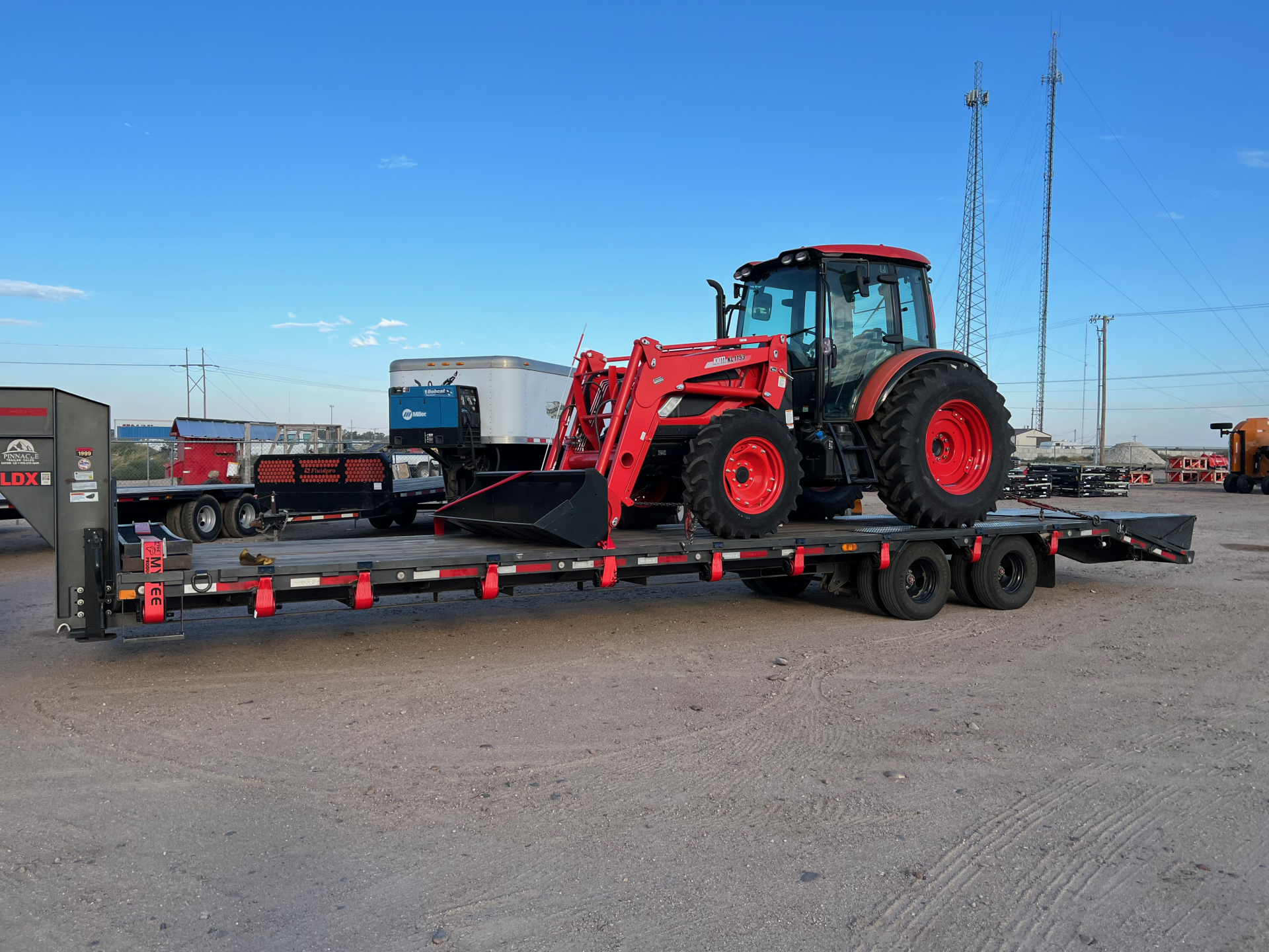 red tractor on a heavy duty trailer