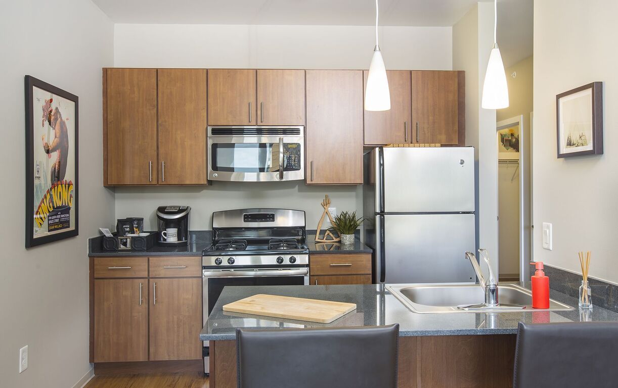 A kitchen with stainless steel appliances and wooden cabinets