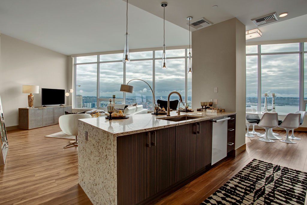 A kitchen with a large island and lots of windows