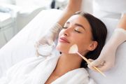 Minimal line-art face with closed eyes, gold accents, and decorative stars on a white background