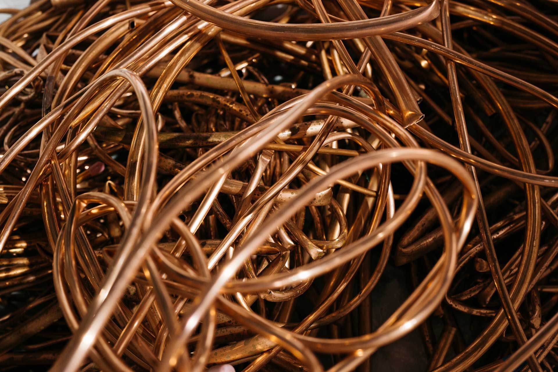 A tangled pile of shiny, bright copper wire strands.