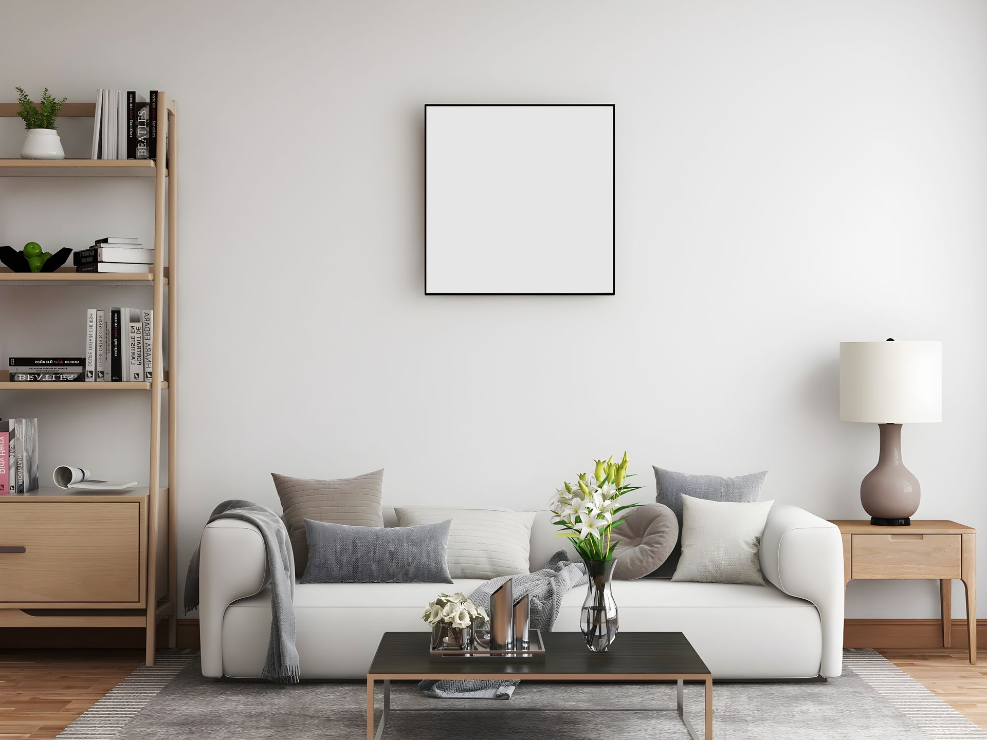 Arbor 29 - A living room with a white couch, a coffee table, a bookshelf and a picture on the wall.