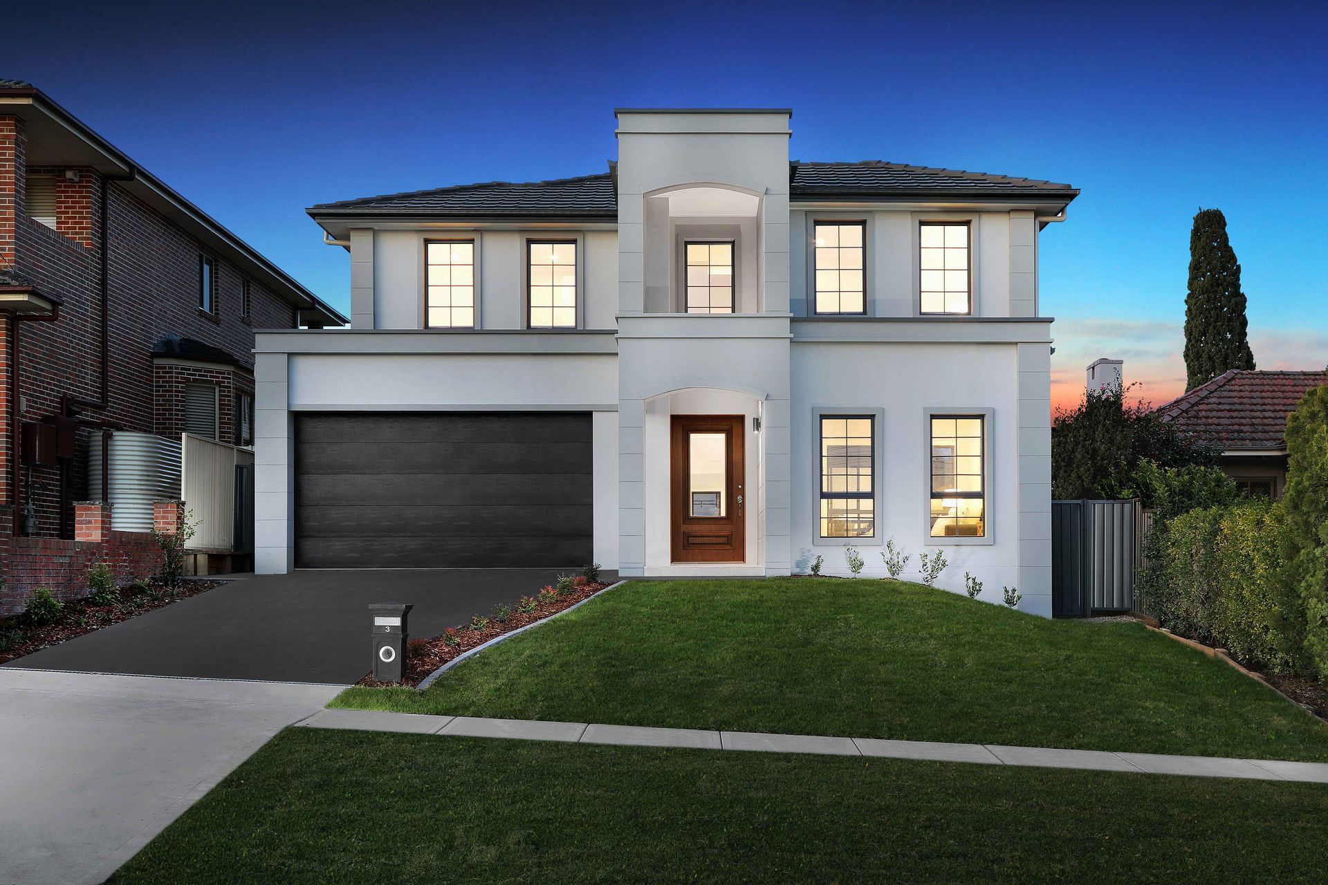 Palazzo 45 home design of a façade of large double-story white house with a black garage door.