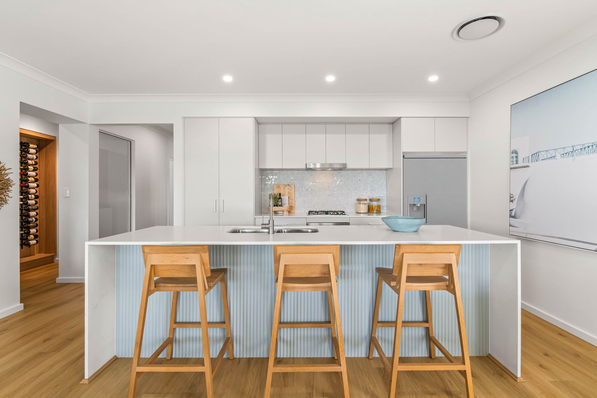 Riviera 31 - Kitchen island with wooden chairs for counter table.