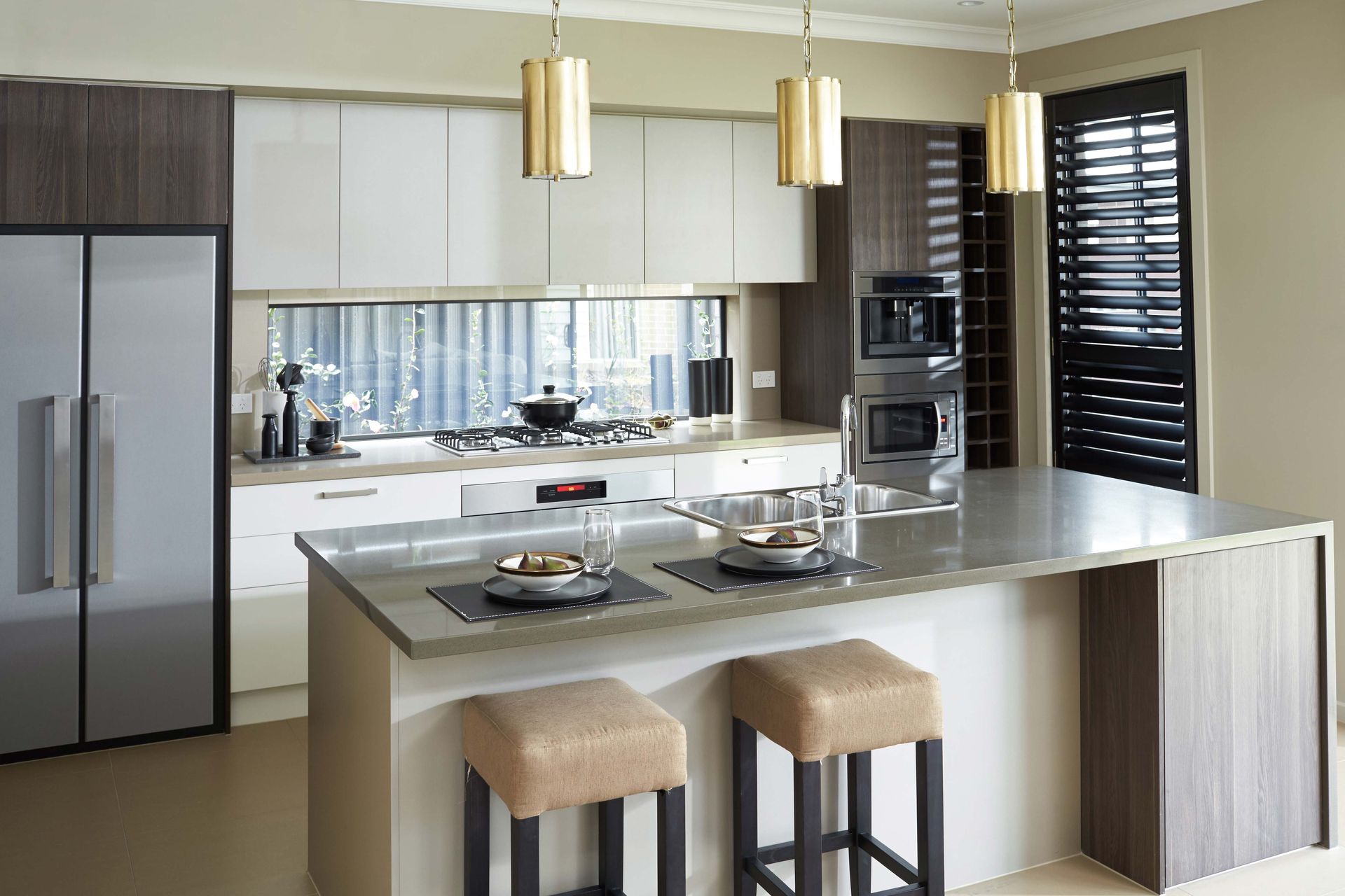 Vineyard 28 home design of a kitchen with a large island and two stools.