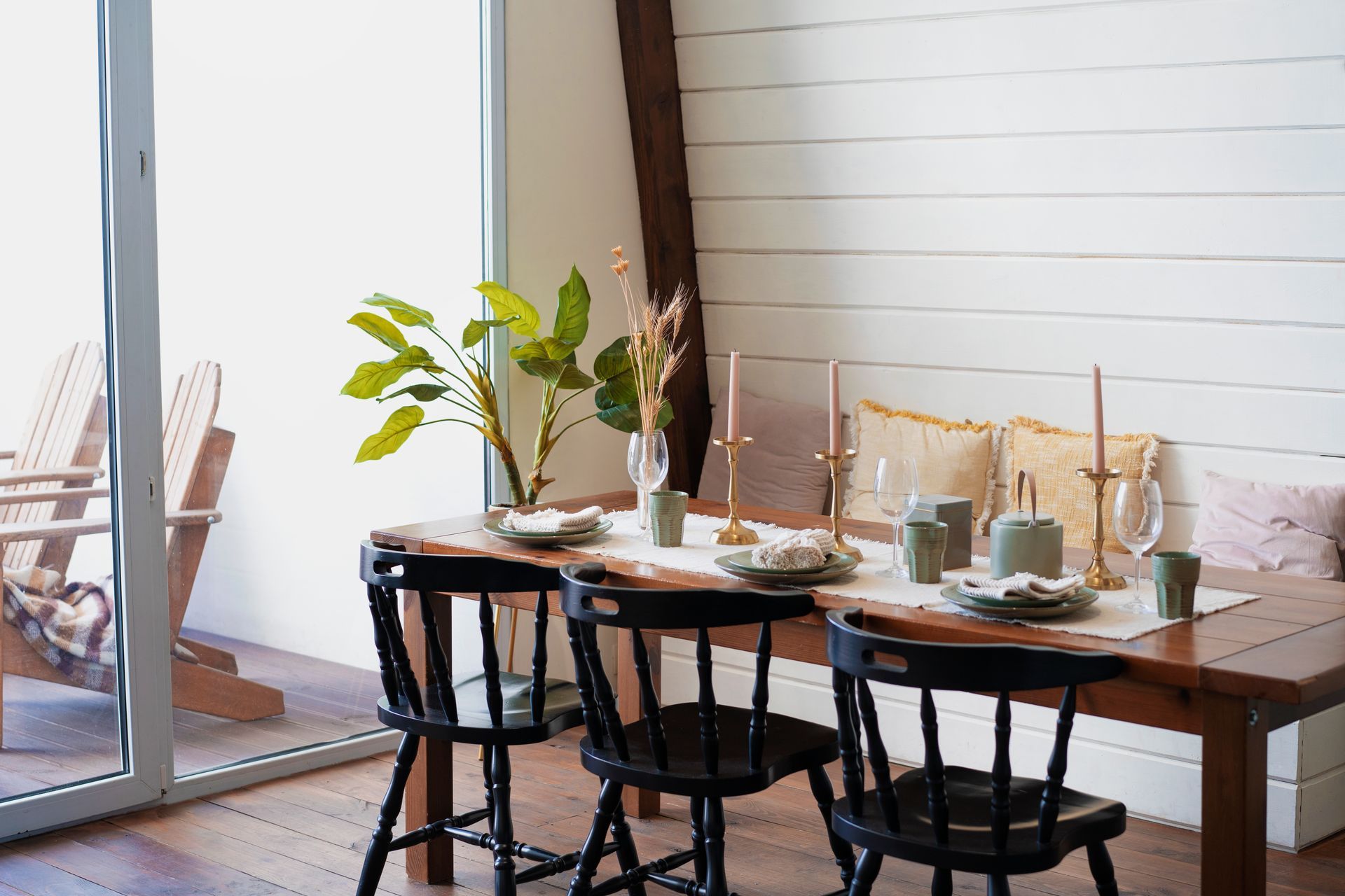 Homestead 33 home design - A dining room with a table and chairs and a sliding glass door.