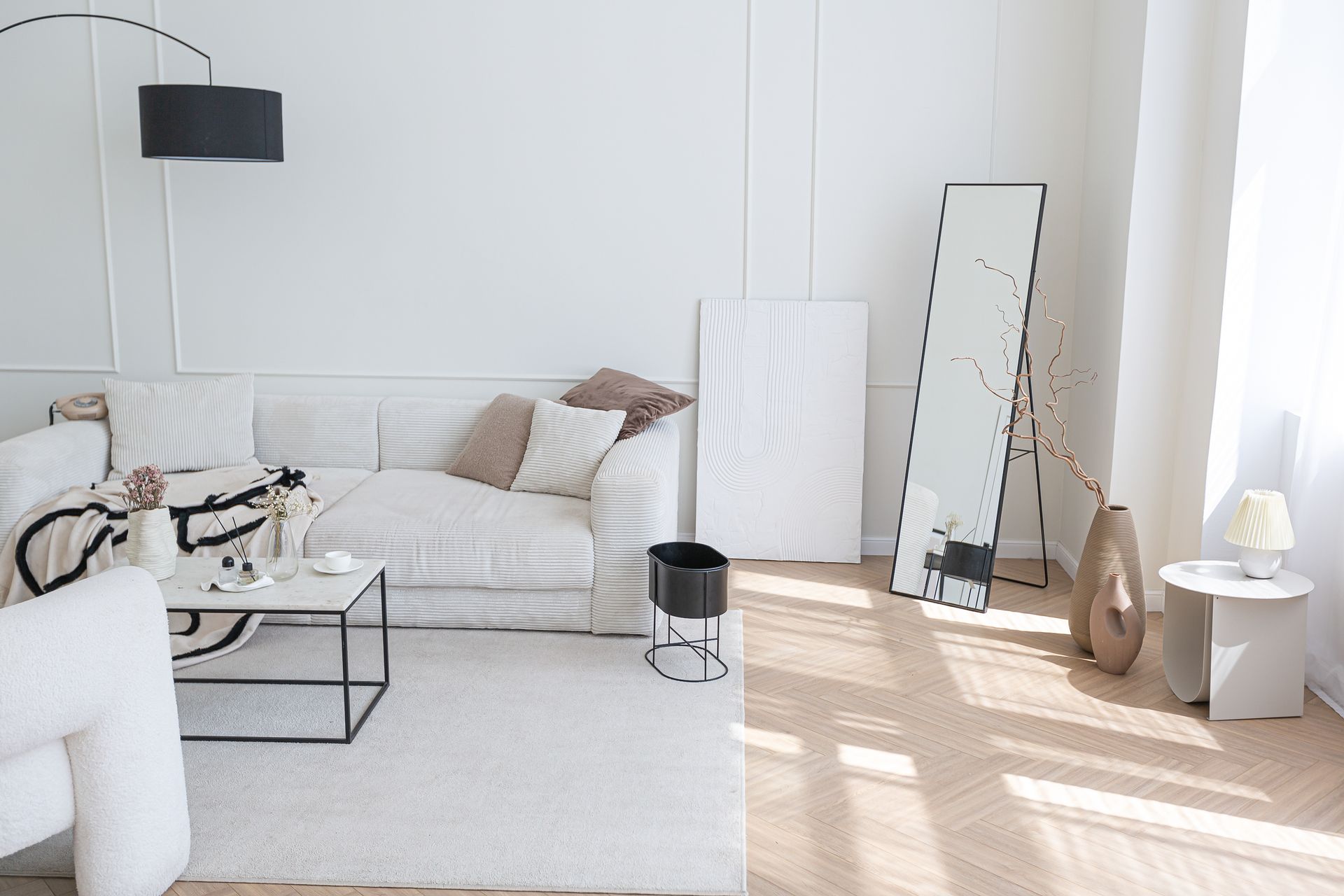 Meadow 28 - A living room with a couch, chair, coffee table and mirror.