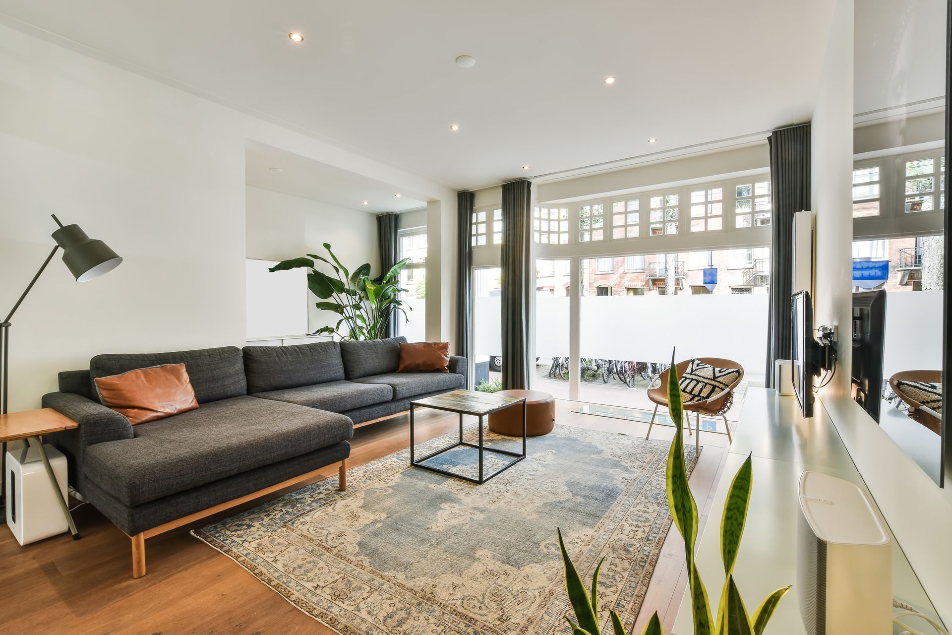 Retreat 32 - A living room with a large sectional couch, coffee table and chairs.
