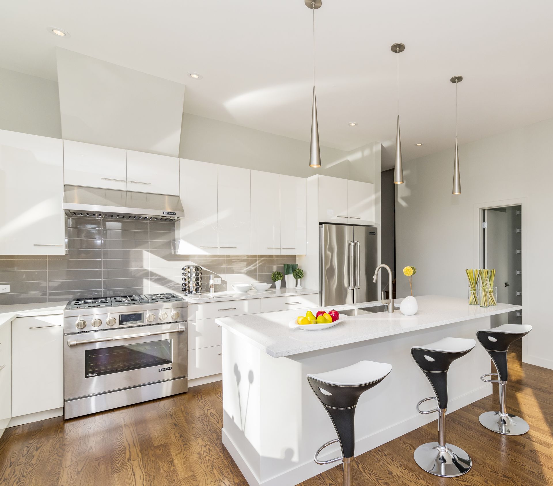 Riviera 24 home design - A kitchen with white cabinets and stainless steel appliances.