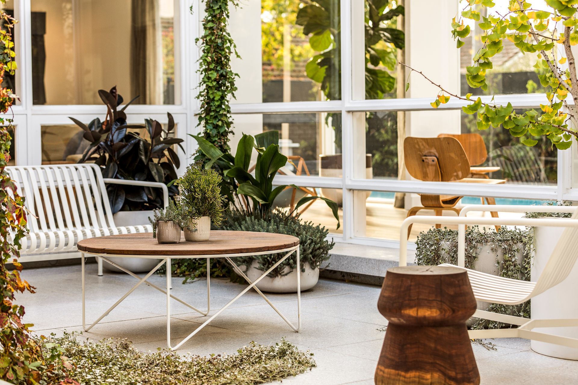 Patio adorned with furniture, lush greenery, and Vista 29 home design