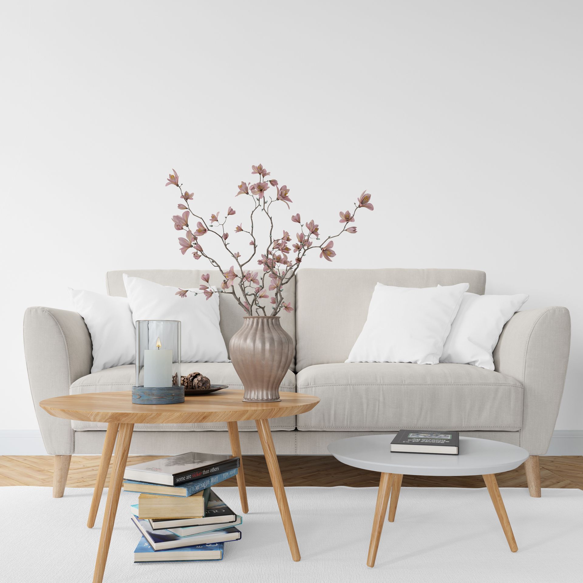 Zen 45 - A living room with a couch, two coffee tables, and a vase of flowers on the couch.