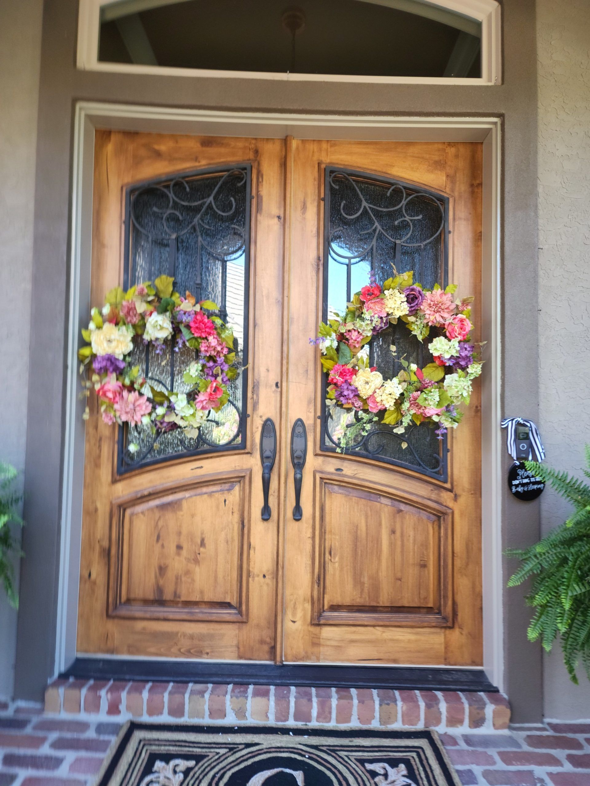 The front door of a house with a wreath on it