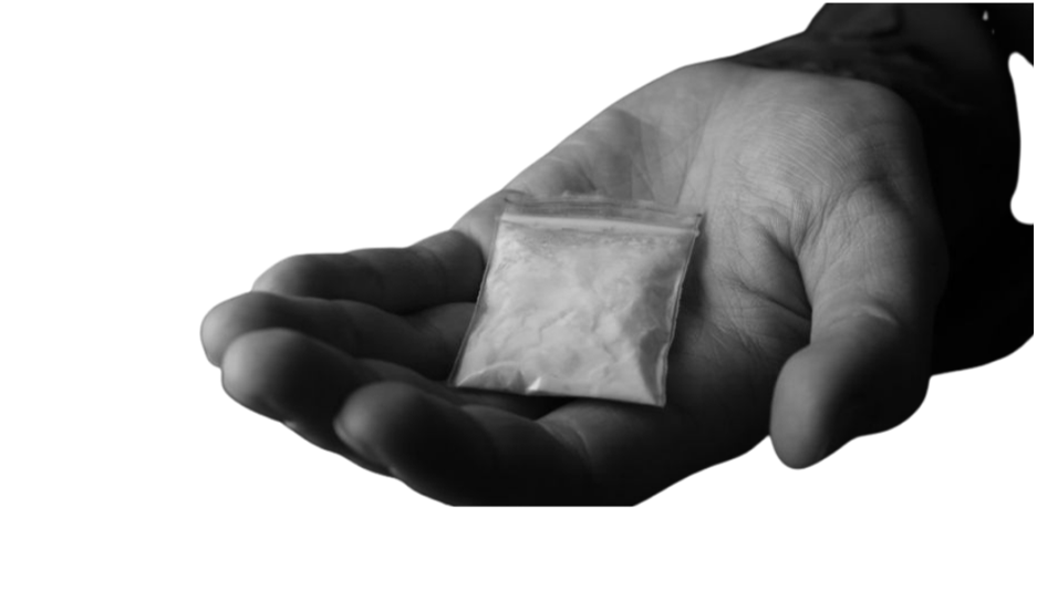 Hand holding a small bag filled with a white powdery substance.