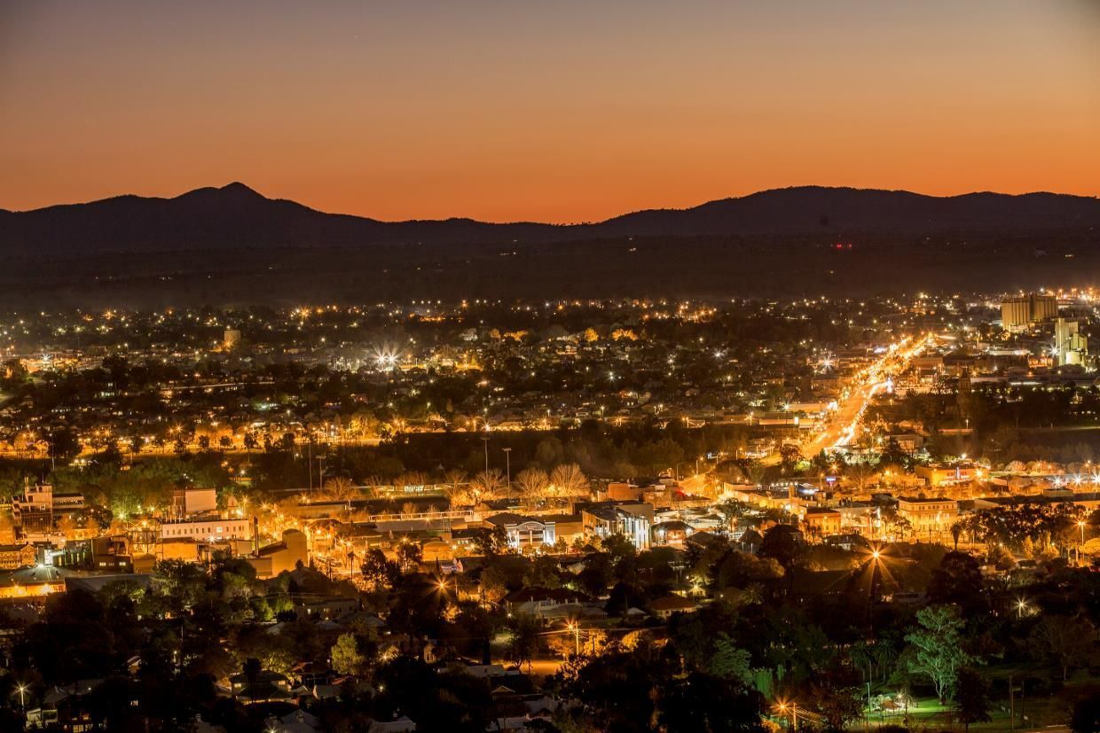 An Aerial View of A City at Night with Mountains in The Background — Thats Tops by Design in Tamworth, NSW