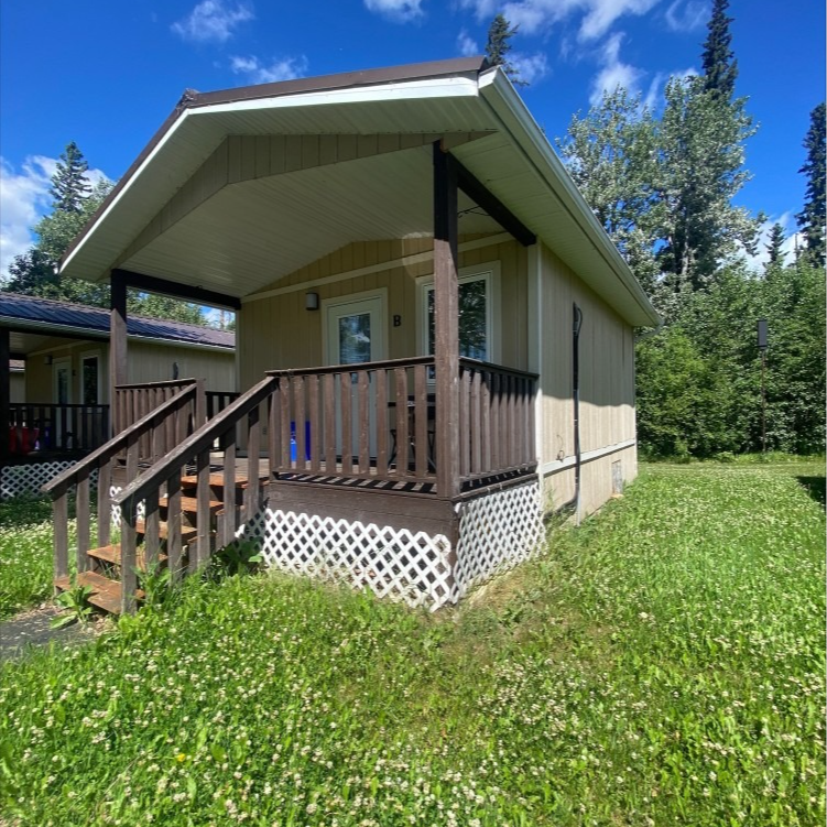 A small house with a porch and stairs