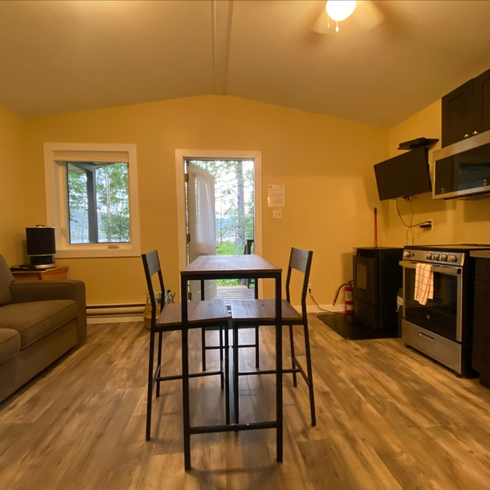 A living room with a table and chairs in it