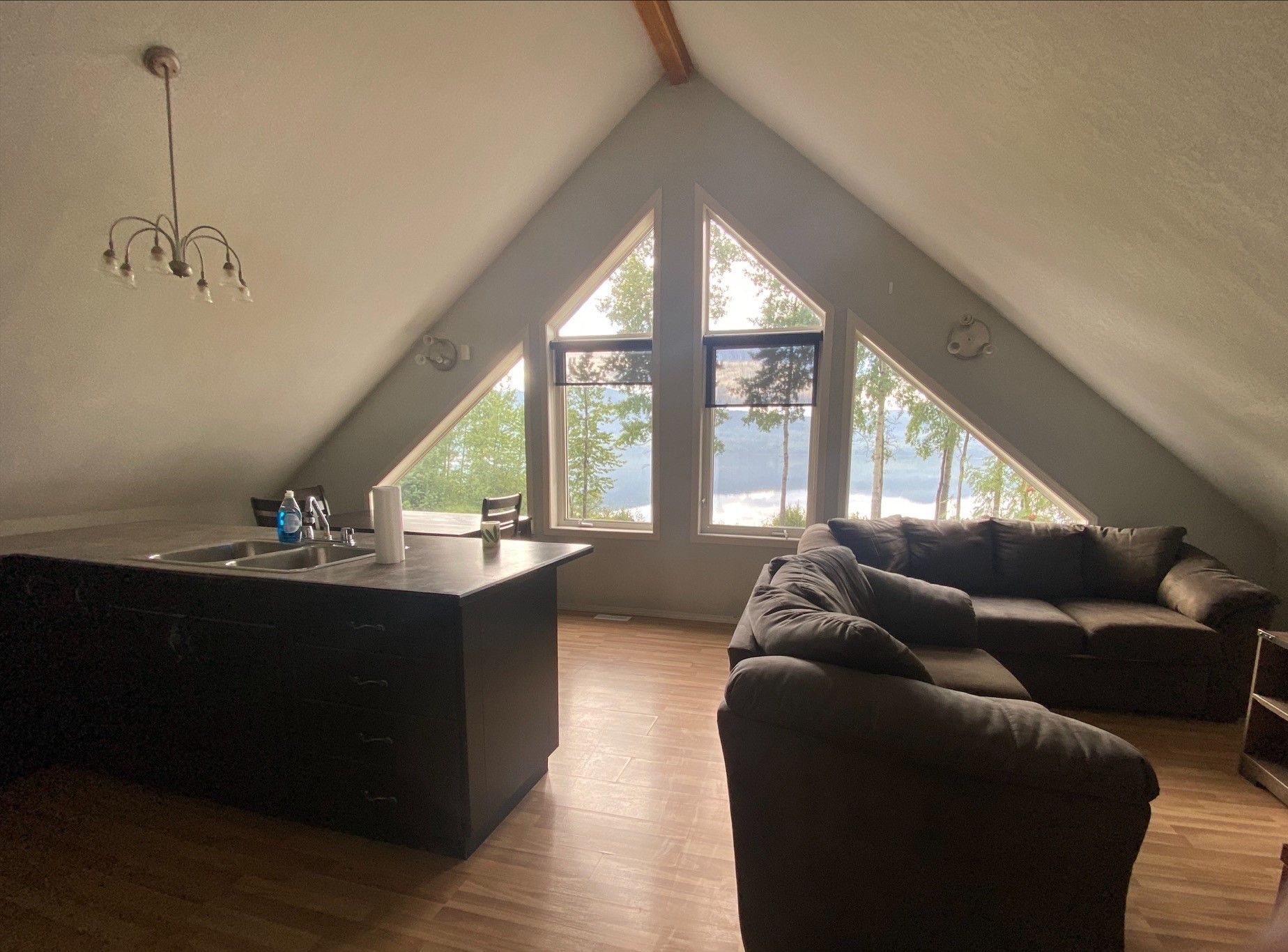 A living room with a lot of windows and a couch.
