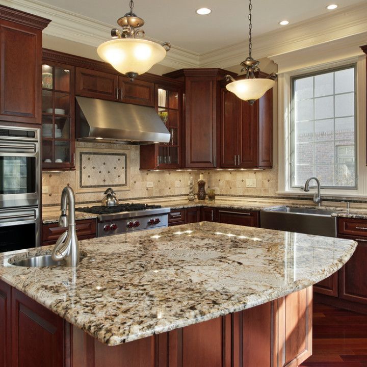 A kitchen with granite counter tops and stainless steel appliances.