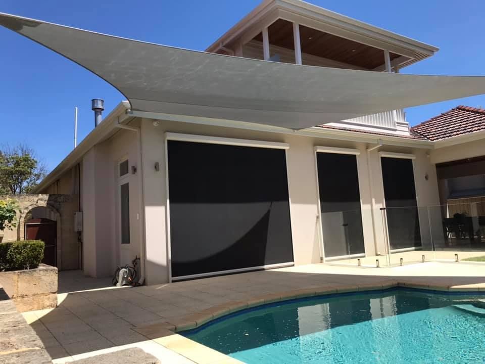 A house with a swimming pool and a shade sail over it