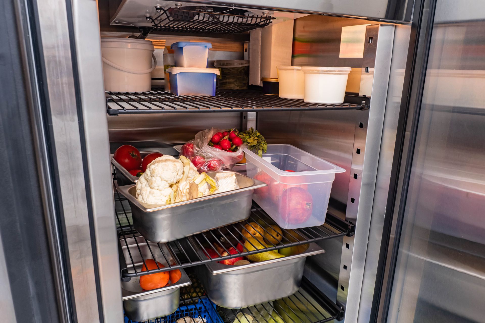 A refrigerator filled with lots of vegetables and fruits