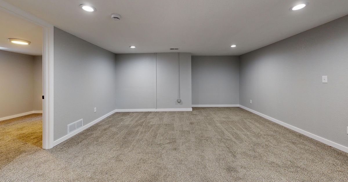 Finished basement family room with egress window in Calvert County home