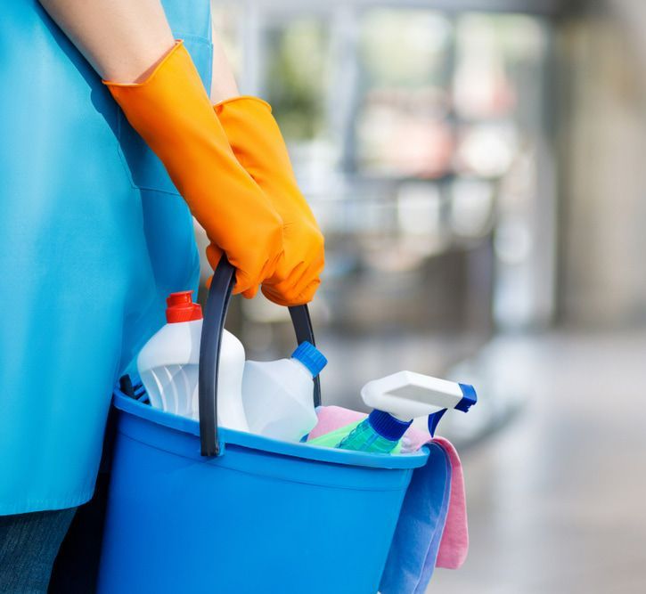 Person Wearing Orange Gloves is Holding a Blue Bucket Filled With Cleaning Supplies — Happy Housekeepers in Gunnedah, NSW